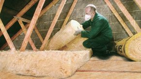 Staff Rolling Out Loft Insulation